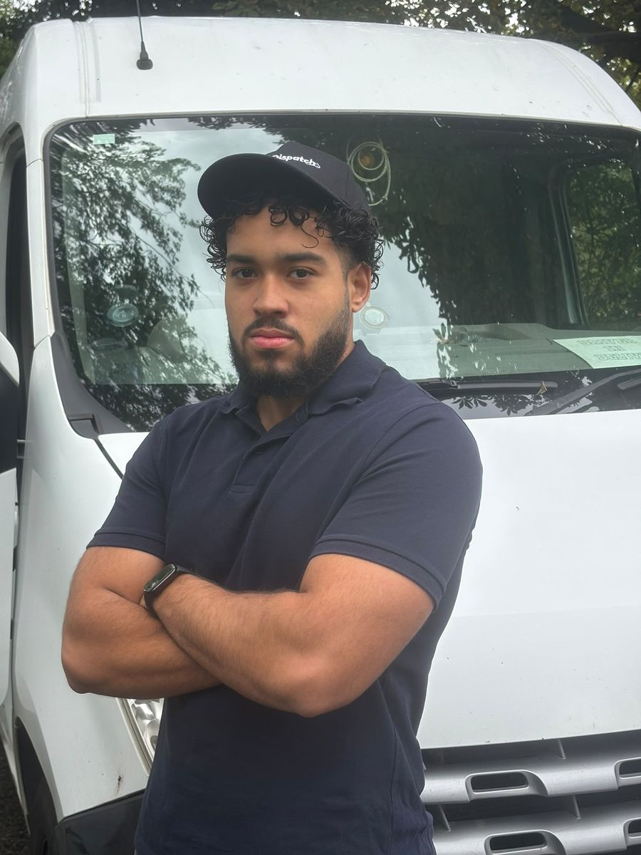 One of the crew in front of the van